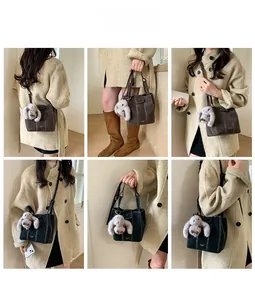 Detail view of vintage bucket bags with contrast stitching and plush bunny pendant accessory