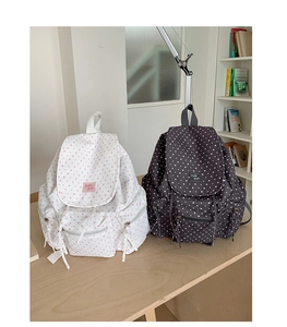 Detail of starry pattern backpacks with drawstring closures and stylish woven labels