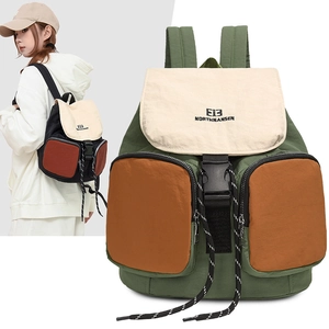 Detail view of hiking backpack showing waterproof nylon fabric and front zipper pockets