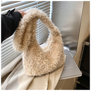 Close-up of beige faux fur hobo bag showing soft lamb wool texture and half-moon shape