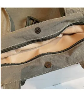 Macro detail of high-density nylon tote bag with metal magnetic snap and precise stitching
