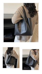 Detail of matte black tote bag showing metal rivet accents and premium leather texture
