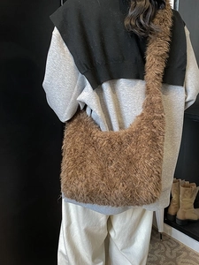 Furry brown plush shoulder bag for women featuring a minimalist faux fur bucket style