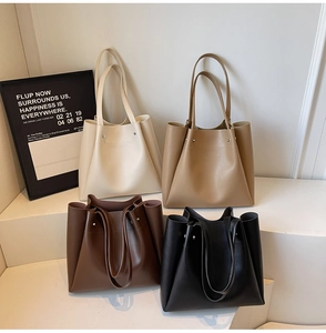 Minimalist matte leather tote bags shown in four classic earth tones on a white display stand