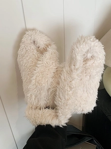 Fuzzy cream faux fur slippers for indoor use featuring a soft and fluffy plush texture