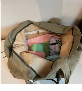 Detail view of the olive green tote bag showing spacious interior with zipper pocket and magnetic snap