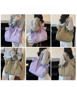 Detail view of large nylon tote bag in purple and olive green with drawstring design