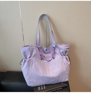 Close-up of lilac nylon tote bag featuring natural crinkled texture and woven rope details