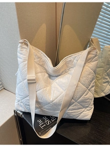 White quilted large tote bag with padded rhombus pattern and wide adjustable shoulder strap
