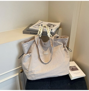 Detailed view of the large capacity tote bag featuring thick rope handles and side pockets