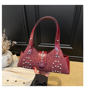 Detail view of burgundy leopard print handbag with silver studs and metal hardware
