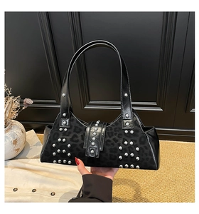 Detail of leopard print suede and silver studs on the black leather armpit bag