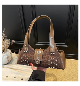 Detailed view of leopard print shoulder bag with silver studs and suede texture