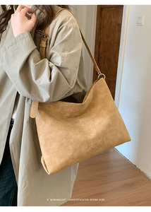 Detail of camel suede tote bag with contrast stitching and leather Fashion label