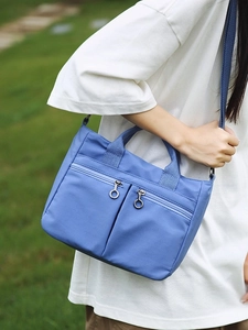 Blue-purple nylon crossbody bag with dual zip pockets and adjustable shoulder strap
