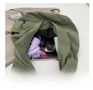 Interior view showing the large capacity of the army green nylon tote for daily essentials