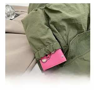 Detail shot of a large side pocket on an army green tote bag with reinforced stitching