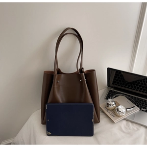 Spacious tote bag capacity shown with a laptop, tablet and headphones inside