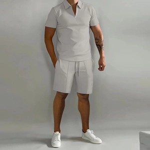 Detail of light gray men polo set with half-zip collar and elastic drawstring shorts