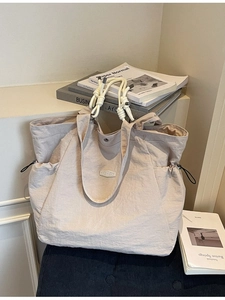 Minimalist large capacity tote bag in beige nylon with braided handles and shoulder strap