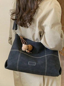 Deep grey large capacity tote bag with white contrast stitching and plush charm