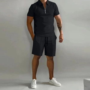 Detail of men's black polo set showing zipper collar and breathable knit texture