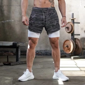 Detail of men's quick-dry camouflage gym shorts with white inner layer in a gym setting