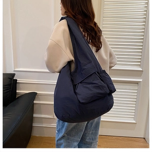 Detail of navy blue lightweight tote bag with side drawstring and spacious compartment