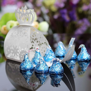 Macro detail of white laser-cut candy gift box with crown top and floral pattern