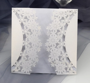 Elegant white laser-cut snowflake wedding invitation cover with pearl finish