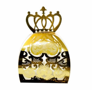 Macro shot of gold hollow crown candy box with laser-cut heart floral patterns