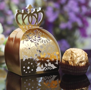 Detailed close-up of golden laser-cut crown candy box with intricate hollow patterns