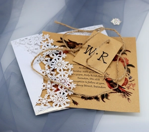 Laser cut snowflake wedding invitation with kraft paper robin card and jute twine detail