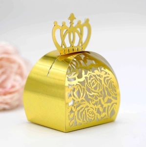 Detail of golden crown handle and laser-cut rose patterns on the hollow candy gift box
