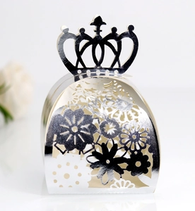 Macro shot of laser-cut floral patterns on silver mirror finish wedding candy boxes