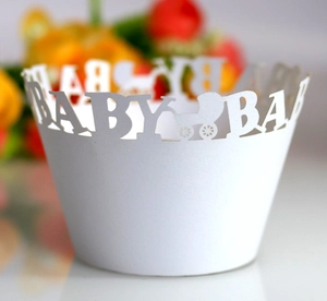 Close-up of laser-cut baby shower cupcake wrappers featuring stroller and BABY design