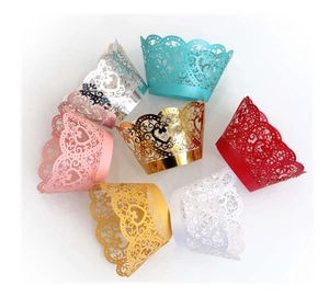 Macro view of laser-cut cupcake wrappers with heart lace patterns in seven assorted colors