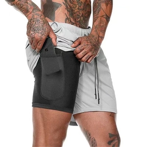 Detail of inner compression layer with hidden phone pocket on double-layer shorts