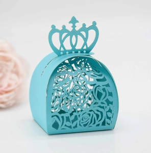 Detail of light blue crown laser-cut gift box featuring intricate rose patterns