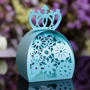 Elegant light blue laser-cut candy box with crown handle and floral patterns