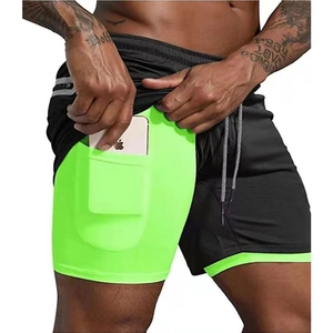 Detail view of men's 2-in-1 shorts with phone pocket on the neon green inner layer