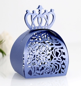 Detailed laser-cut rose pattern on royal blue crown candy box with pearlescent finish