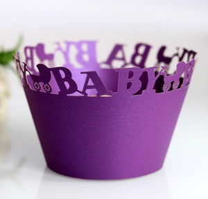 Close-up of laser-cut purple pearl paper cupcake wrapper with hollow baby stroller pattern