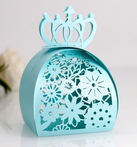 Close-up of laser-cut crown paper gift box in light blue with floral hollow pattern