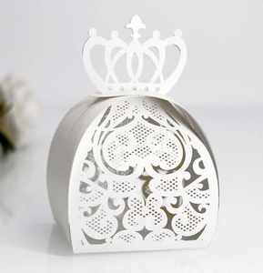 Detailed laser-cut white heart and flower patterns on elegant crown gift box
