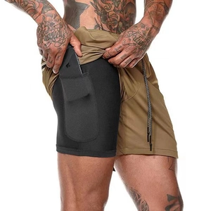 Detail view of khaki running shorts with built-in black compression liner and phone pocket