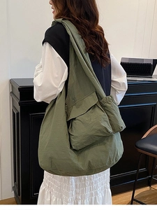 Lightweight green oversized tote bag with functional pockets and drawstring detail