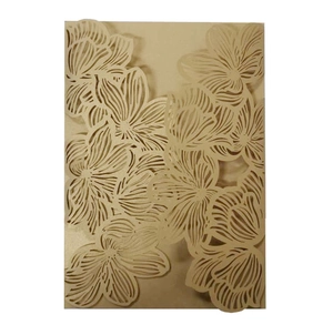 Close-up of laser-cut cream wedding invitation cover with intricate floral rose patterns