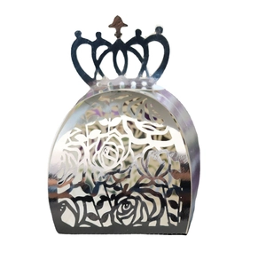 Detail of silver mirror crown favor box with intricate laser-cut rose patterns
