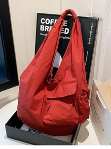Minimalist red oversized shoulder bag with unique textured fabric and front flap pocket